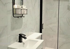 A bathroom with a white sink, a black faucet, and a mirror with a black frame. - The Red Lounge House - sleeps 14 (Liverpool)