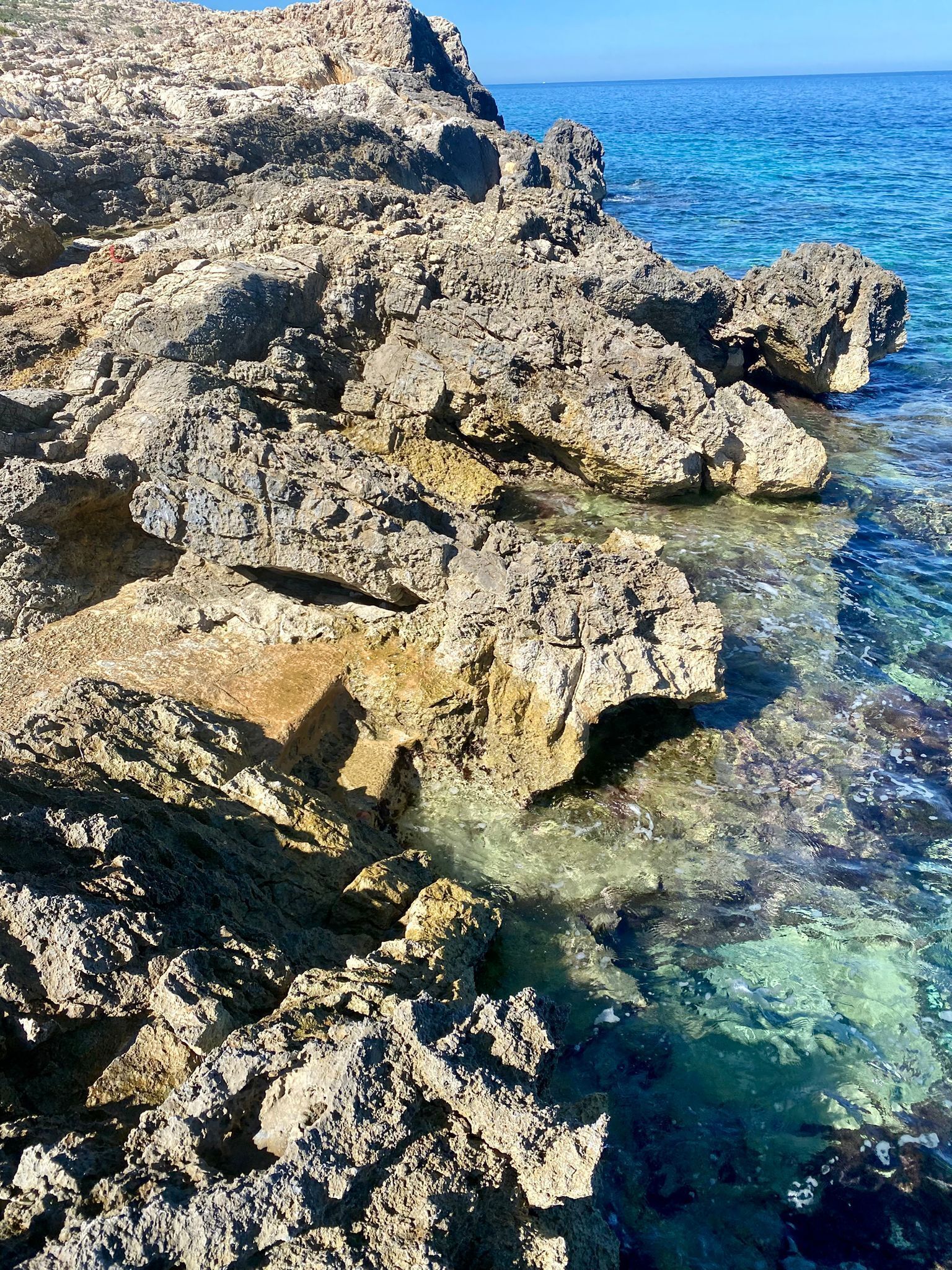 A rocky coastline with clear water.