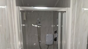 A modern shower area with a glass door, a handheld showerhead, and a control panel. - The Red House, 2 Bed Garden Flat in Totterdown, Bristol BS3 4TJ near city centre (Bristol)