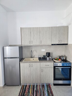 Apartment, 1 Bedroom, Courtyard View, Ground Floor | Private kitchen | Full-size fridge, oven, stovetop, cookware/dishes/utensils - Parian Nissos Harmony Living (Paros)