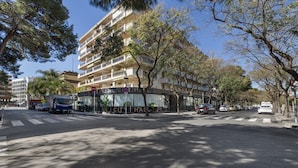 A multi-story building with balconies, a crosswalk, and parked cars. - Holiday Home 'Salou Blueme' with Mountain View, Wi-Fi and Air Conditioning (Salou)