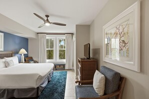 A hotel room with a bed, a desk, a chair, a dresser, a ceiling fan, and a window with curtains. - 3 Bedroom and 3 Bathroom Condo in Lasata (Miramar Beach)