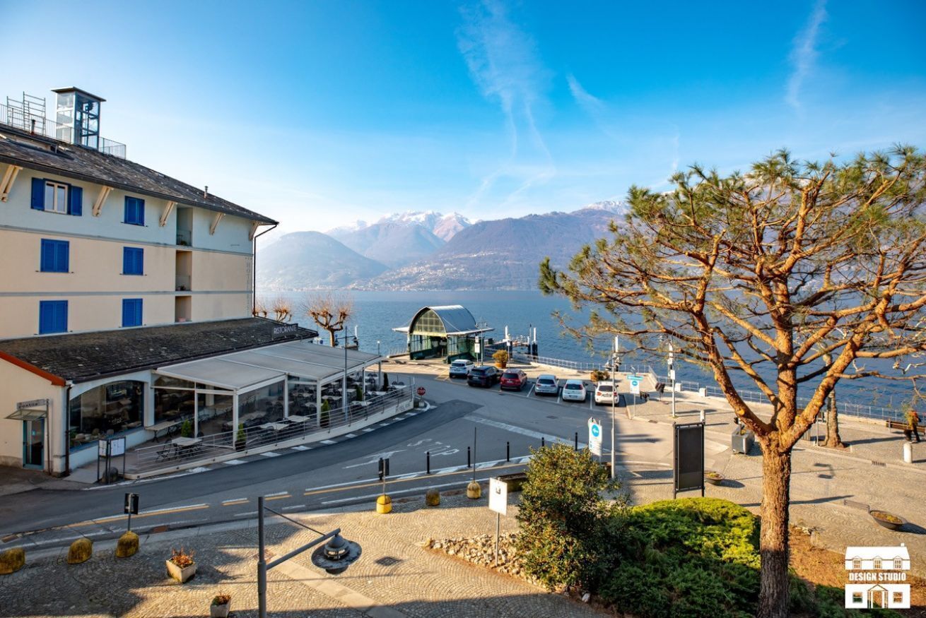 A coastal hotel with a view of the sea and mountains.