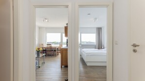 Ein Hotelzimmer mit Bett, Schreibtisch und Blick ins Freie.