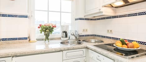 Fridge, stovetop, dishwasher, coffee/tea maker