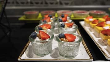 A tray of food items, including what appears to be chia pudding topped with fruits and nuts.