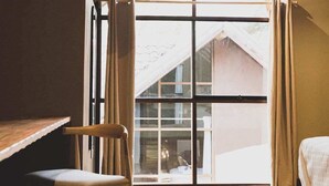 A room with a wooden ceiling, a large window with curtains, a wooden chair, a bed, and a rug. - w Peaceful 2BR Riverside Villa in Sacred Valley (Calca)