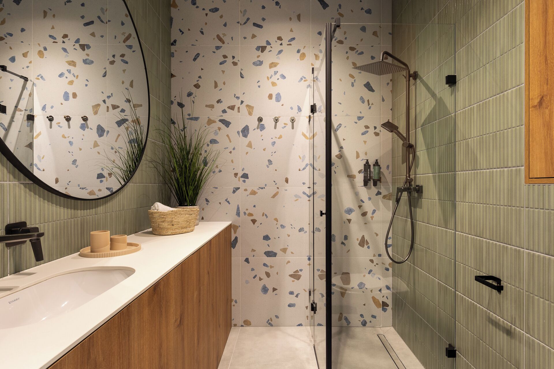 A modern bathroom with a freestanding bathtub, a large mirror, and a wooden vanity.