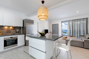 A modern kitchen with a central island, stainless steel appliances, and a patterned backsplash. - Alluring Rhodes Villa | Villa Lindia | 3 Bedrooms | Private Pool | Lovely. (Lindos)