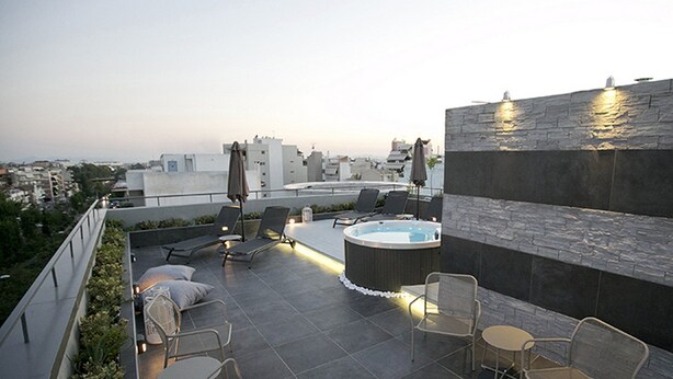 A rooftop terrace with a hot tub, lounge chairs, and umbrellas. - Alluring Athens Maisonette | Apollo Heights Maisonette | 1 Bedroom | Superb. (Athens)