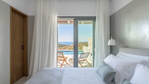 A bedroom with a large bed, a view of the sea, and a balcony with a pool. - Lavish Milos Suite | Apollo Heights Suite | Panoramic Views of Milos villages. (Milos)