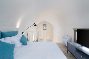A bedroom with a bed, a TV, a desk, and a window. - Villa Eunomia, 2 BDR, Wonderful Seaviews, Private Pool, Santorini (Santorini)