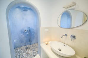 A bathroom with a blue-tiled shower, a white sink, and a mirror. - Villa Ioneira, Sea Views, Outdoor Hot Tub, Furnished Terrace, Santorini (Santorini)