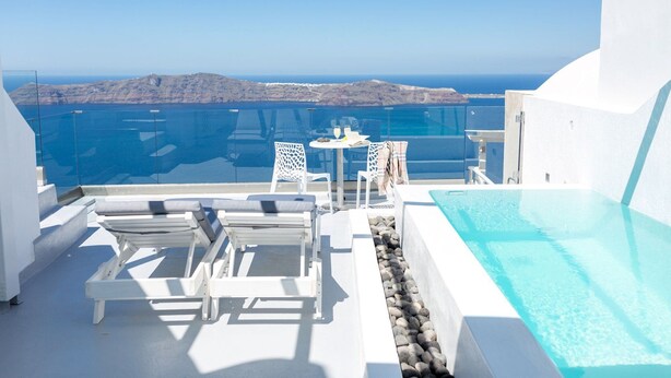 Une terrasse sur le toit avec une piscine, des chaises longues et une table où sont servis des boissons.