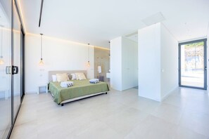A modern bedroom with a bed, bedside tables, and a large window. - Villa Vista Albufeira | Sea Views | Heated Pool | Walk to Marina (Albufeira)