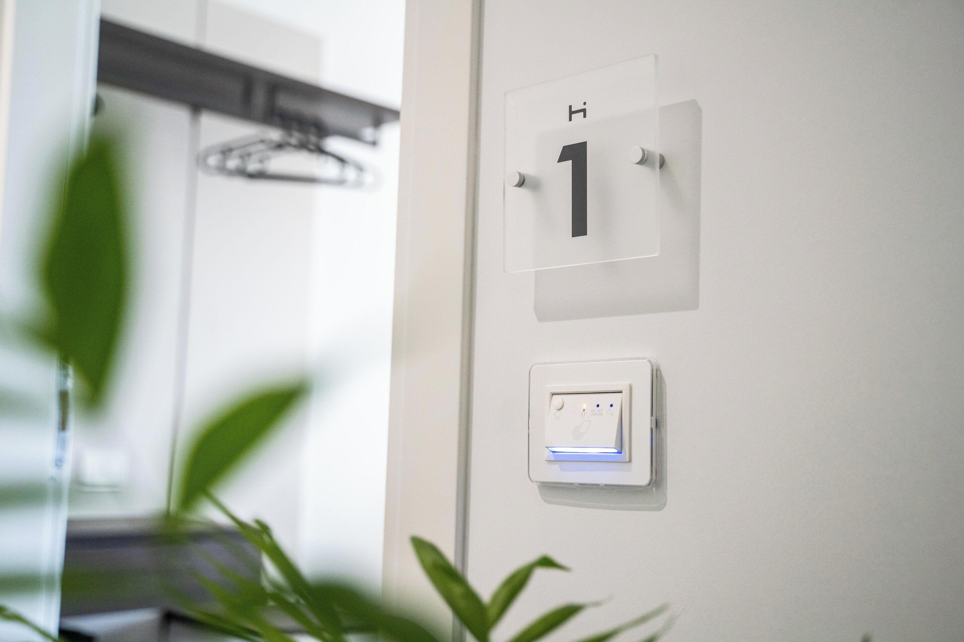 A wall-mounted number plate labeled '1' and a thermostat with a blue light indicator.