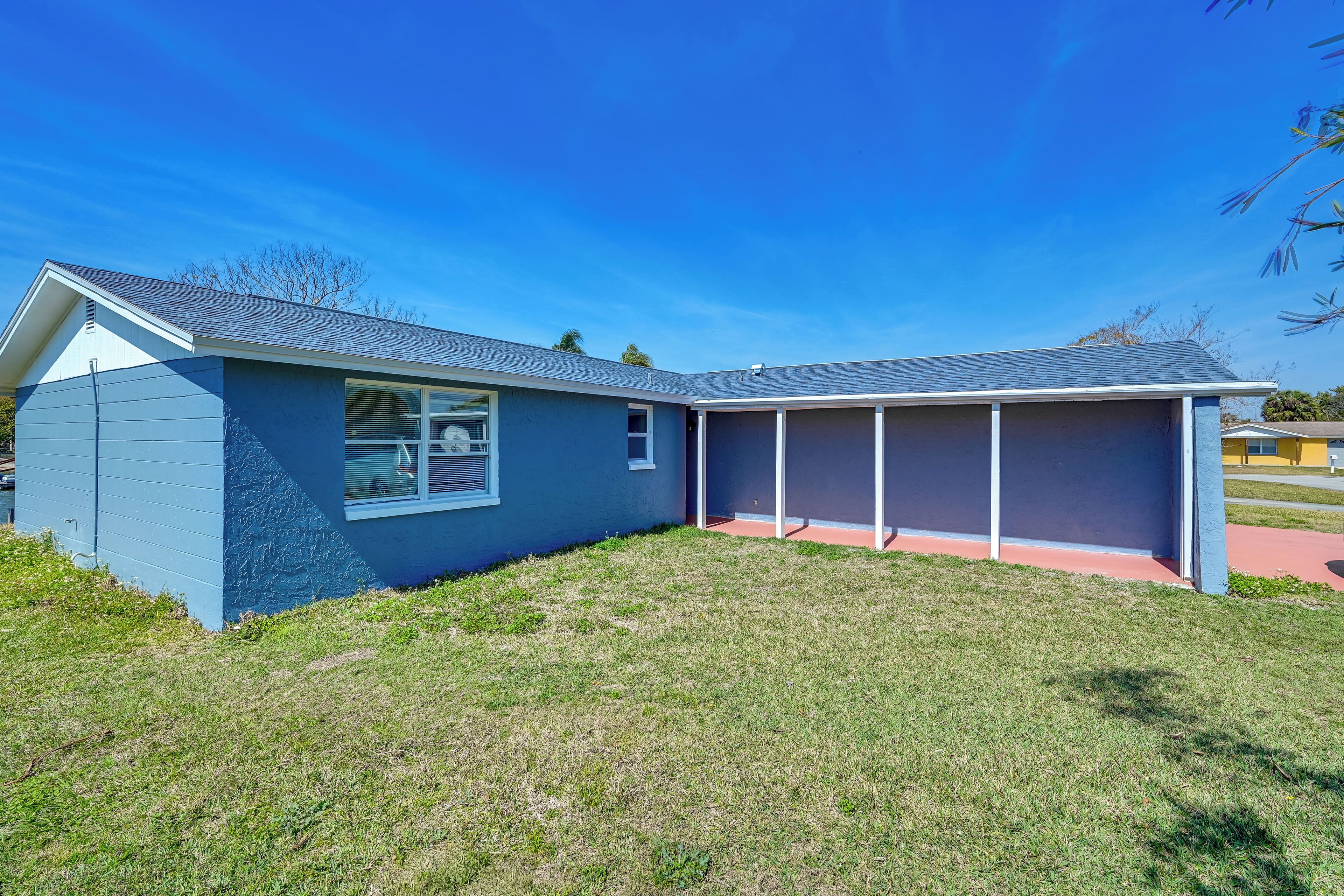 A single-story house with a blue exterior and a covered porch.