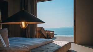 A bedroom with a large bed, a sitting area, and a view of the sea. - Rhethis Suite, Divine Sea Views, Infinity Pool, Oia (Santorini)