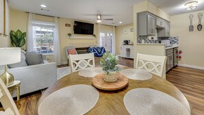 A dining area with a wooden table, woven placemats, and a central plant. - Great for Families! Quiet Auburn Getaway w/ Deck (Auburn)