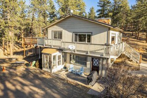 A two-story house with a balcony, a covered porch, and a garage. - Pet-friendly Pine Home: Near Hiking & Fishing! (Pine)