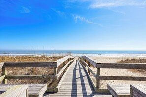 A wooden boardwalk leading to a beach with a clear sky. - Sun, Surf & Group Fun in Carolina Beach! Luxe Home (Carolina Beach)
