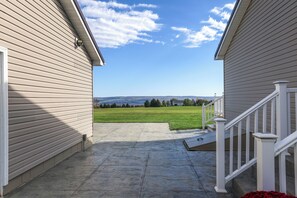 A house with a covered patio leading to a grassy field. - Explore + Relax: Gem Near Watkins State Park Gorge (Watkins Glen)