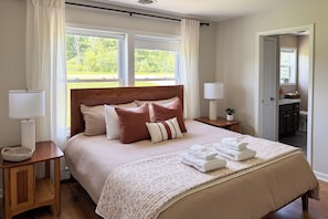 A neatly made bed with a headboard, bedside lamps, and a window with curtains. - Explore + Relax: Gem Near Watkins State Park Gorge (Watkins Glen)