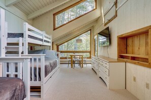 A bedroom with bunk beds, a desk, a chair, and a dresser. - Resort-style Community! Quechee Chalet w/ Deck (Quechee)