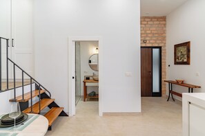 A modern interior with a staircase, a bathroom, and a dining area. - TRES PINOS APARTMENT (Mijas)