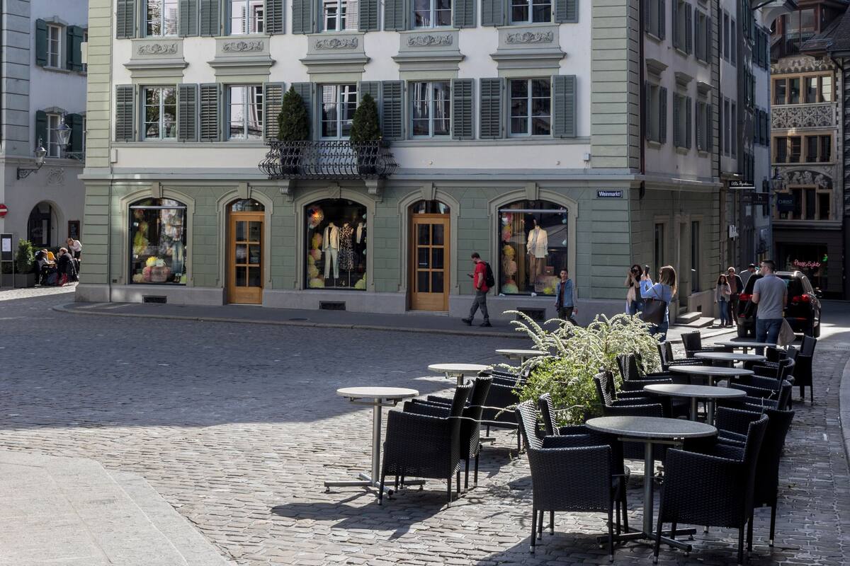 A historic building with a prominent sign for 'HOTEL KRONE,' featuring a classic European architectural style with symmetrical windows and a central entrance.