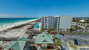 A beachfront hotel with a pool, beach access, and a parking area. - Islander Beach Resort 705 Condo (Fort Walton Beach)