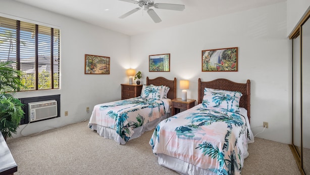 A hotel room with two beds, a ceiling fan, a window with blinds, and artwork on the walls. - Wailea Grand Champion, #78 2 Bedroom Condo (Kihei)