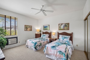 A hotel room with two beds, a ceiling fan, a window with blinds, and artwork on the walls. - Wailea Grand Champion, #78 2 Bedroom Condo (Kihei)