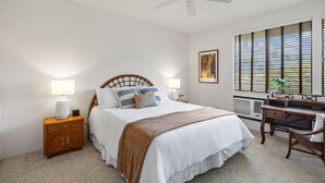A bedroom with a bed, bedside tables, a desk, and a ceiling fan. - Wailea Grand Champion, #78 2 Bedroom Condo (Kihei)