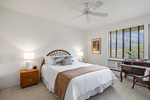 A bedroom with a bed, bedside tables, a desk, and a ceiling fan. - Wailea Grand Champion, #78 2 Bedroom Condo (Kihei)