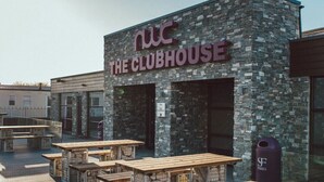 An outdoor seating area with wooden tables and benches at The Clubhouse. - C43 The Hideout (Abergele)
