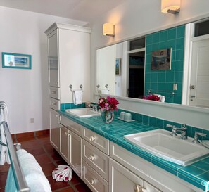 A bathroom with two sinks, a large mirror, and a cabinet. - Private 4BR Oceanview Villa - Private Pool - Peaceful Hilltop Setting (Crab Hill)