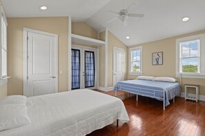 A bedroom with two beds, a ceiling fan, and a window with blinds. - Driftwood Haven at Rivers Bend - Steinhatchee (Steinhatchee)