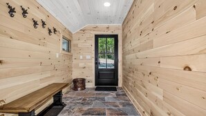 A wooden interior hallway with a bench, a door, and a window. - An Adventure Awaits -  Stepaway Vacation Rentals (St.Germain)