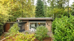 Een modern huis met een terras, een kleine tuin en een garage.