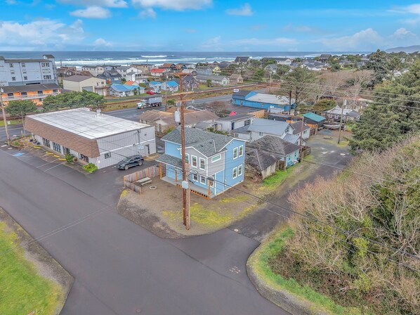 A coastal town with a mix of residential and commercial buildings, including a prominent blue house with a porch. - Two Story Charmer Close to the Beach with Large Kitchen and Fire Pit (Rockaway Beach)