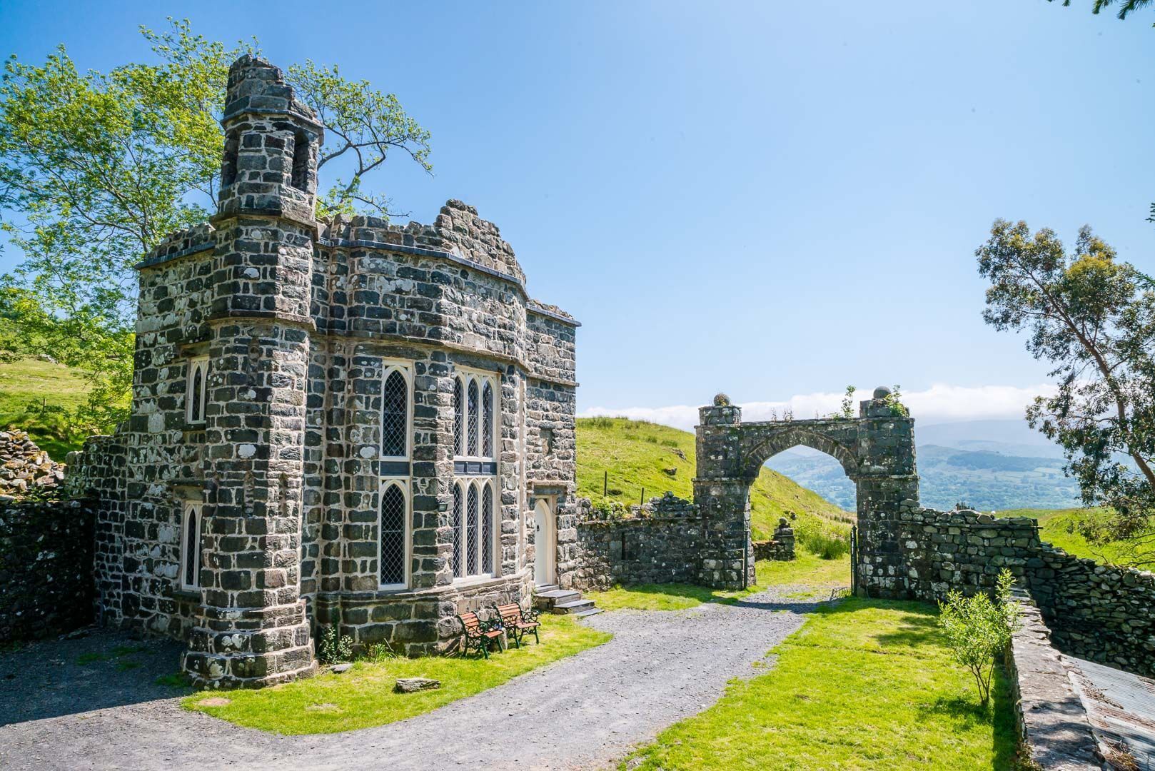 A stone building with arched windows and a stone archway.