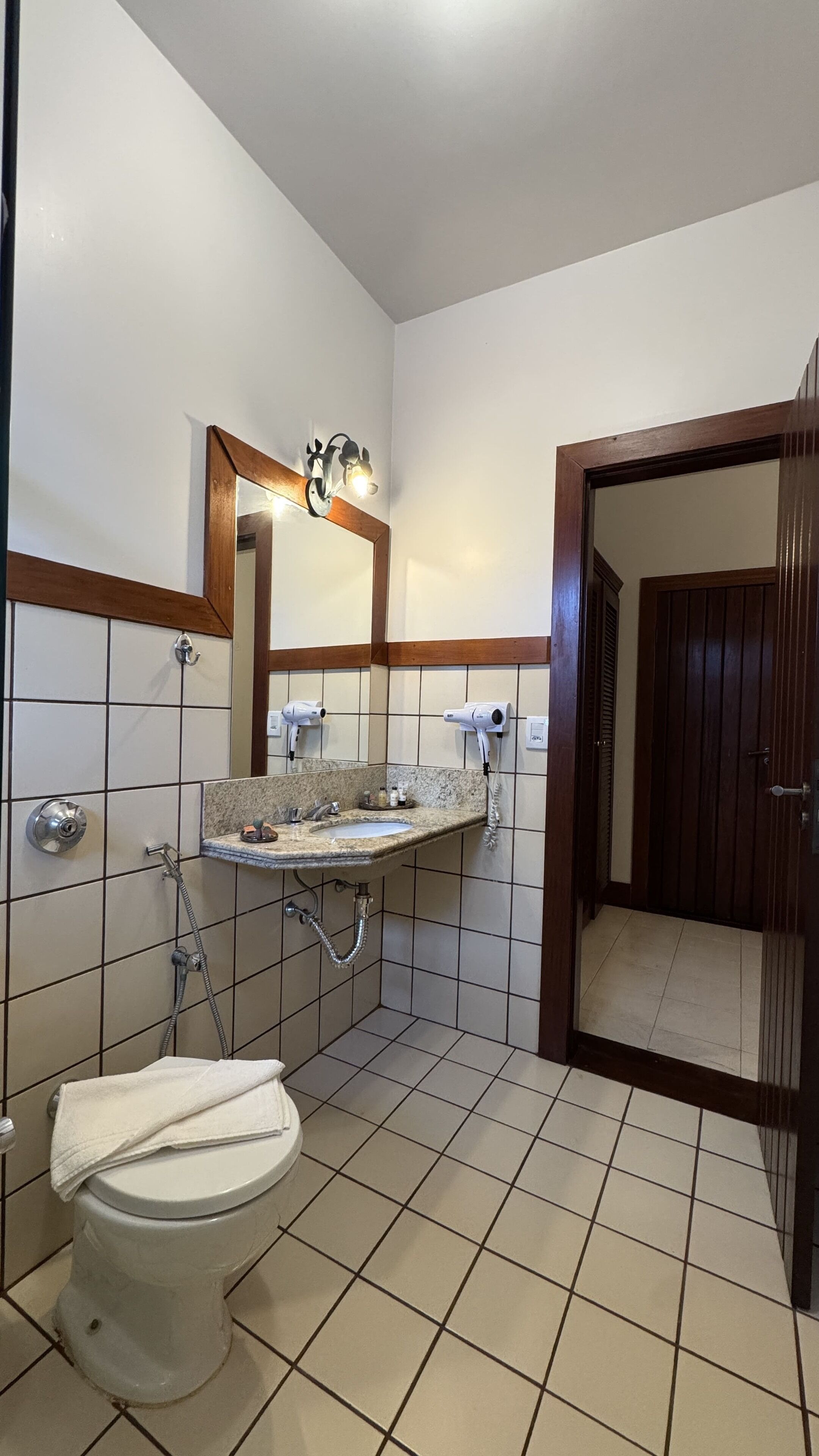 A bathroom with a toilet, sink, and shower.
