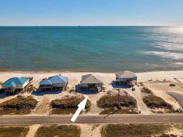 An aerial view of beachfront houses with a road in the foreground. - Sea Turtle - Gulf Beachfront, 5 Bedroom, 4 Bath, Sleeps up to 13 (Dauphin Island)
