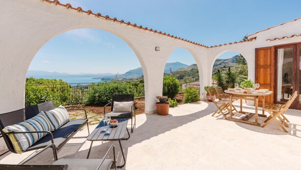 A terrace with a view of the sea, a table with chairs, and a sofa. - Zingaro Anima Maris, between Scopello and Zingaro (CASTELLAMMARE DEL GOLFO)