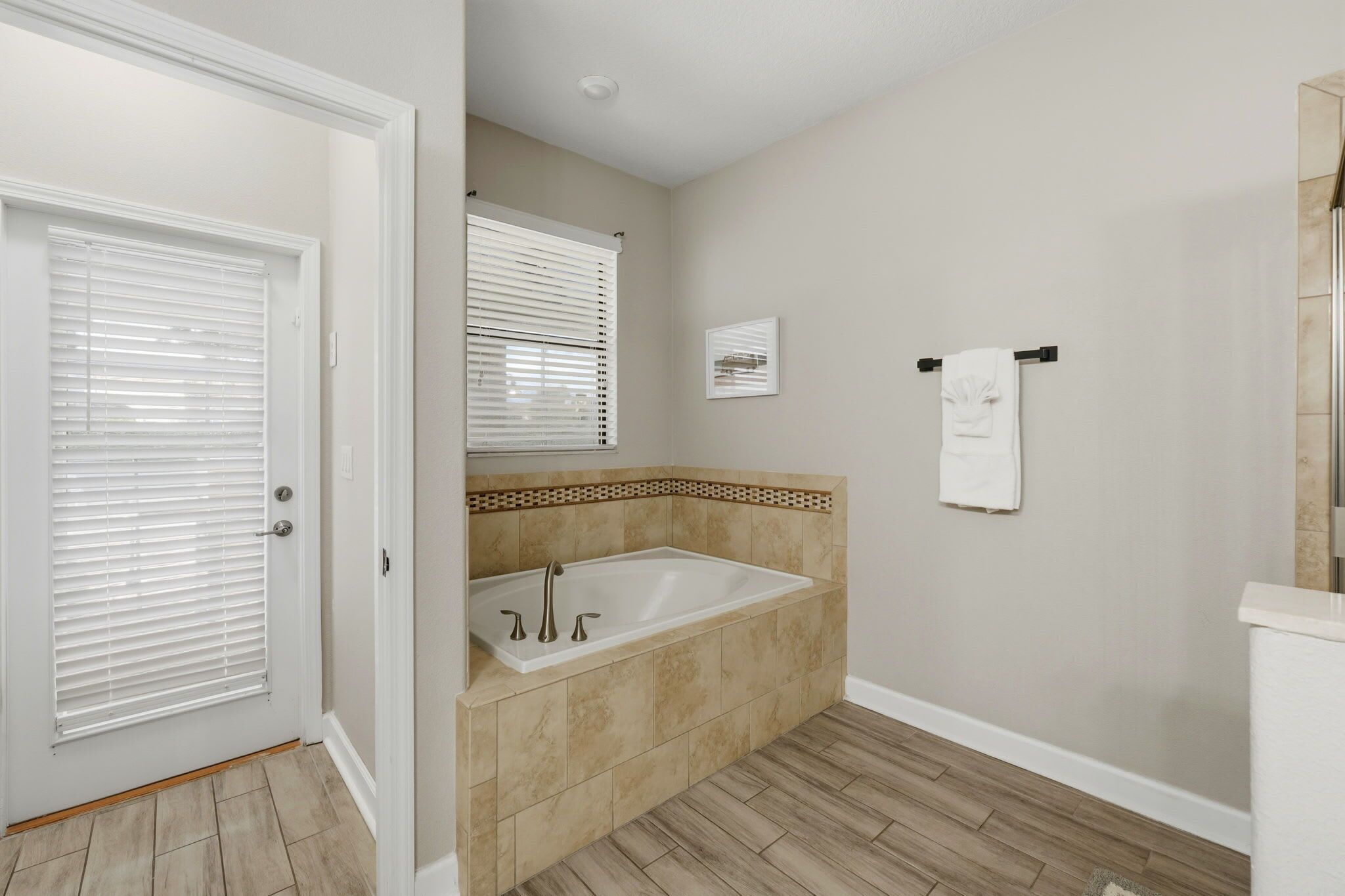 A bathroom with a bathtub, a toilet, and a sink.