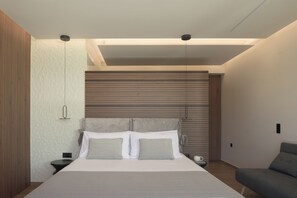 A modern bedroom with a large bed, bedside tables, and a ceiling light fixture.