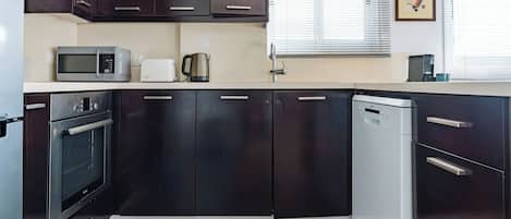 Apartment, City View | Private kitchen | Full-size fridge, microwave, oven, stovetop