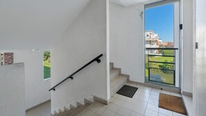 A staircase with a handrail leading to a balcony with a metal railing. - Golf Apartment - Pornic 2 with Shared Pool, Balcony and Wi-Fi (Pornic)