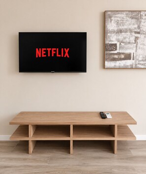 A flat-screen TV mounted on a wall with the word 'NETFLIX' displayed on the screen. - Valencia Urban Suite IX | 4 Guests | A/C & Wi-Fi | Near the City Center (Valencia)